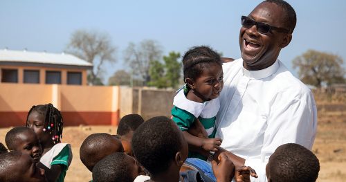 Fr. Clement interacting with school children in Ghana