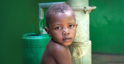 A little boy in a clean water well in Haiti.