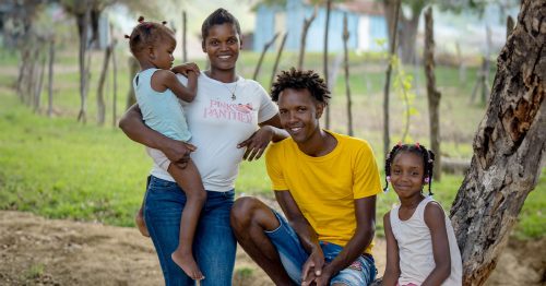 A family of four smile for the camera.
