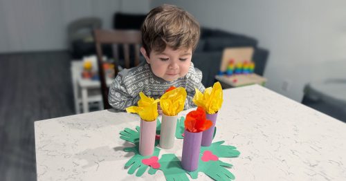 Young boy creating advent wreath.