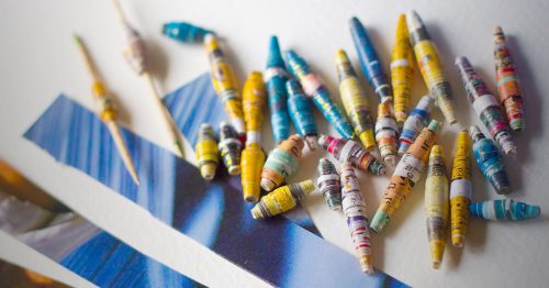 A collection of beads made from paper.