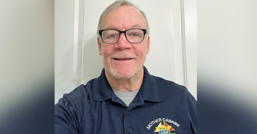 A man in a KOC polo with the name “Bill” embroidered on the left.