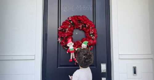 A door with the chalk inscription “20+C+M+B+26.”
