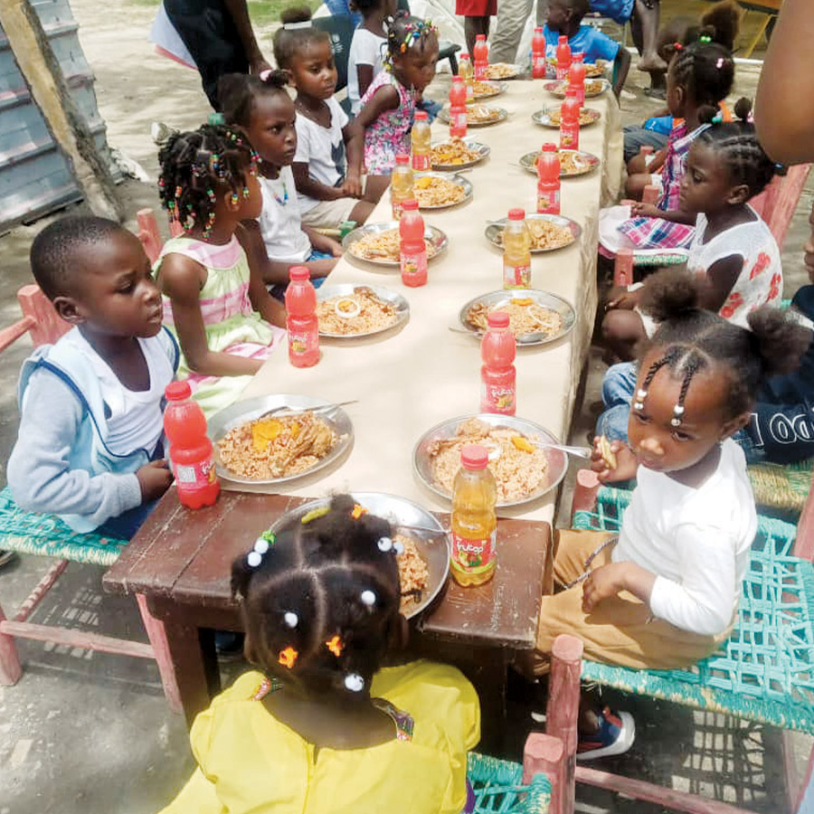 Young children eat a meal.