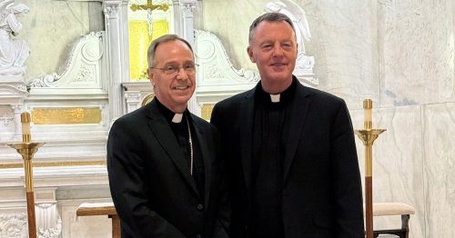 Board Member Archbishop Charles Thompson and Father Dave Caron, O.P., both wearing priestly collars, in the Blessed Sacrament Chapel at Saints Peter and Paul Cathedral in Indianapolis.