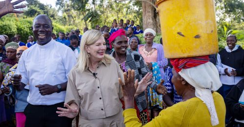 Michele Sagarino smiles and dances alongside villagers.