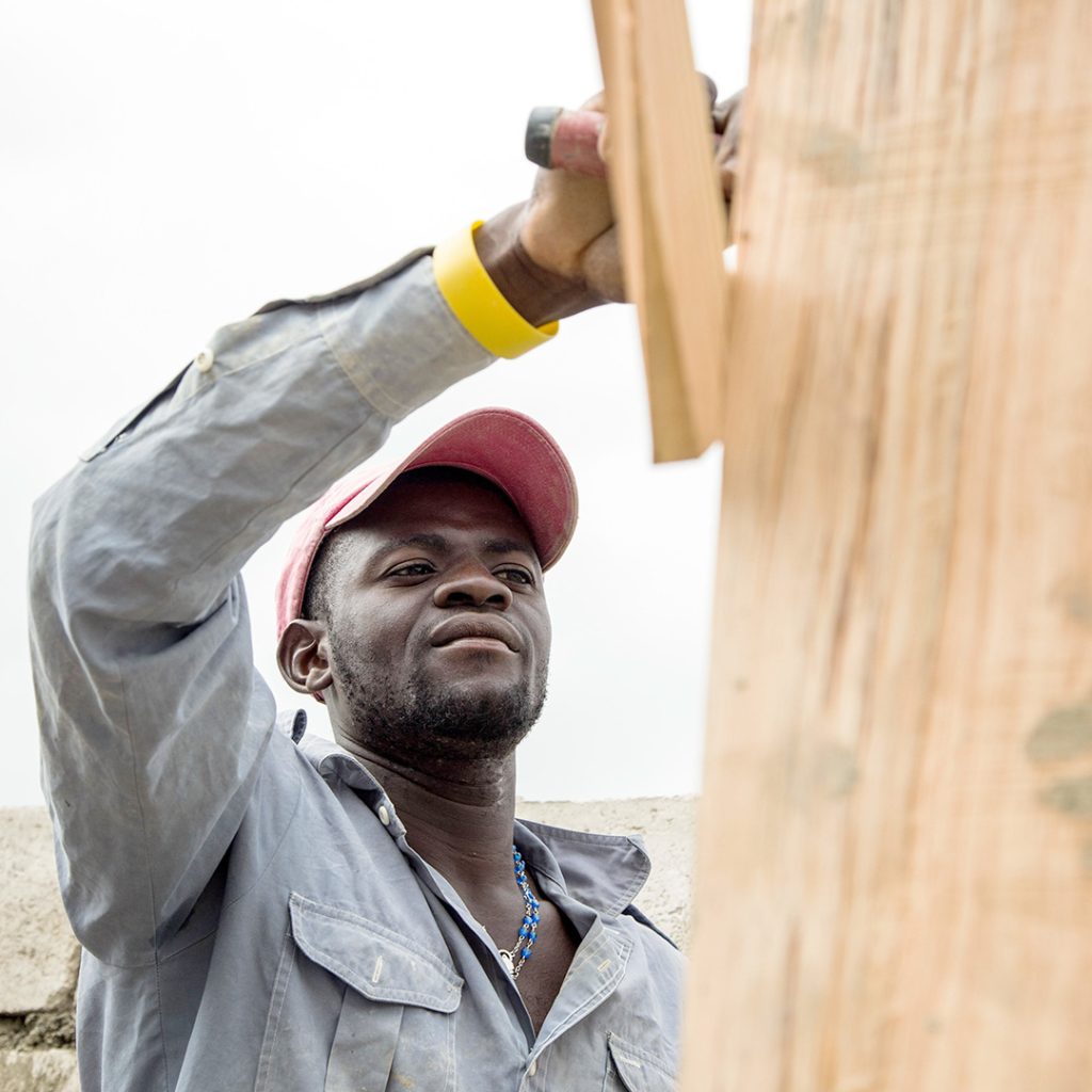 A worker builds the walls of a home.