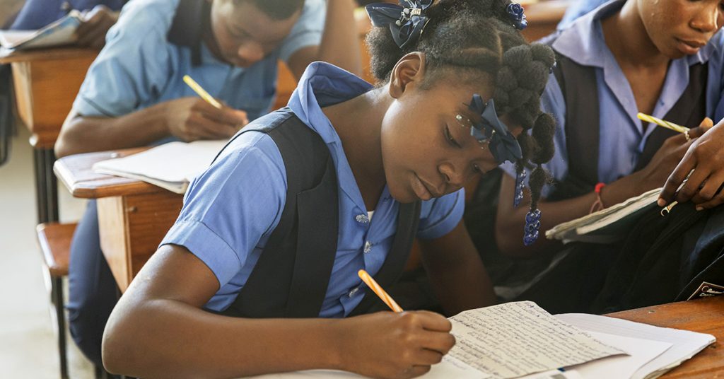 Students taking notes at their desks.